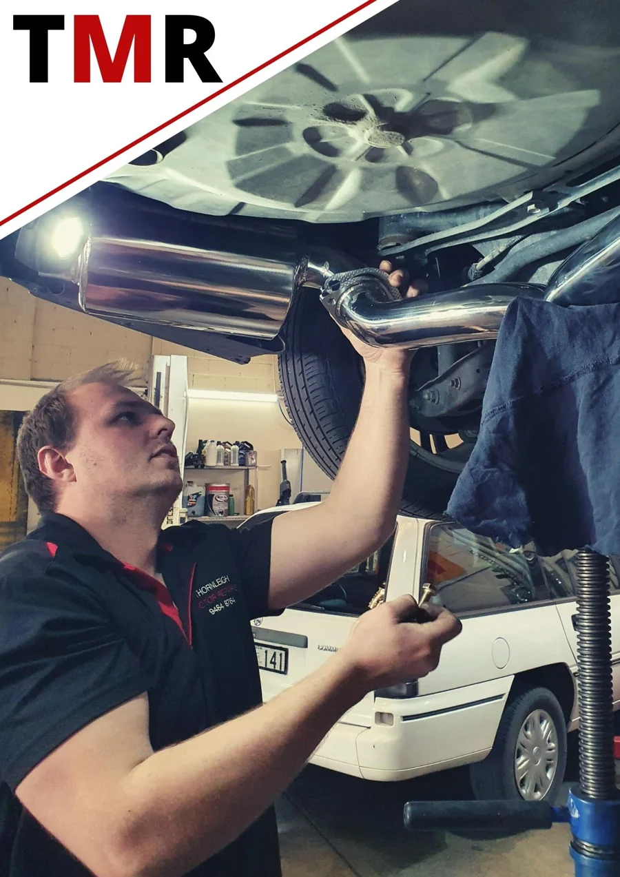 A mechanic working on a vehicle at Thornleigh Motor Repairs