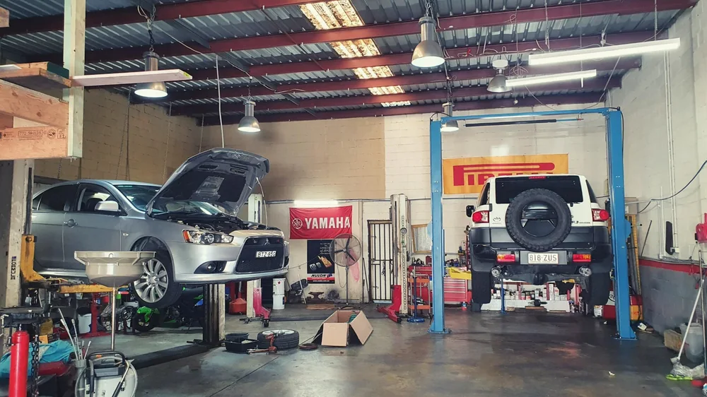 Vehicles on hoists in the TMR workshop
